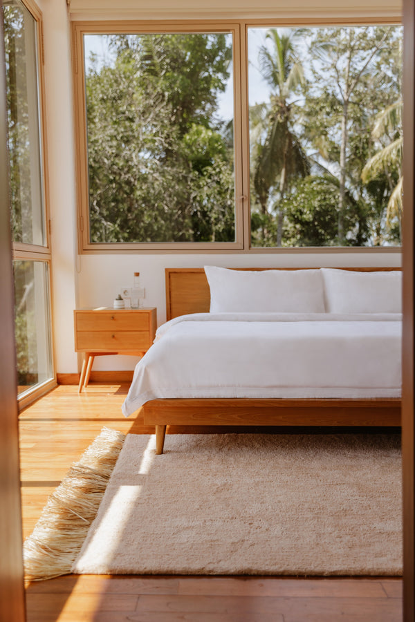 Nomada woven rug in a modern sunlit bedroom